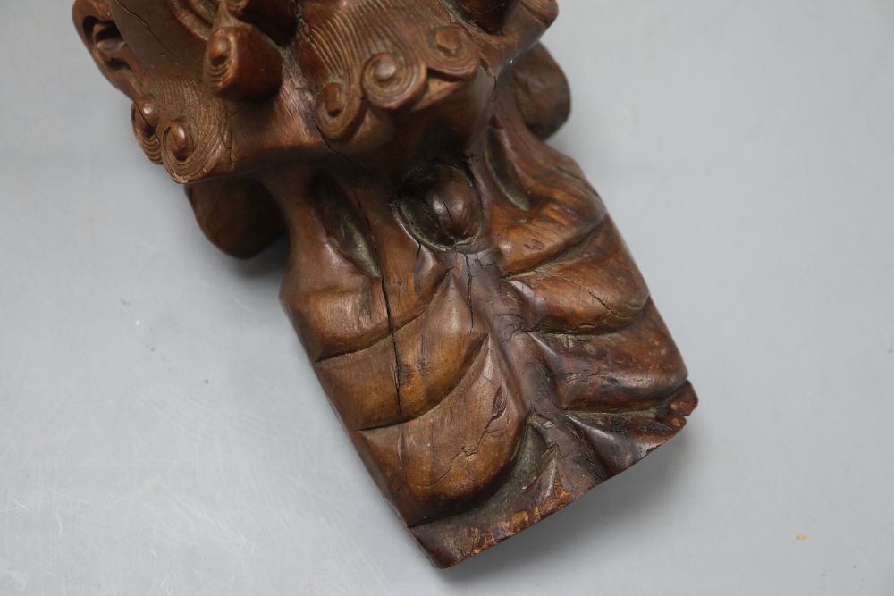 An Oriental carved hardwood head of immortal, with glass eyes, height 22cm